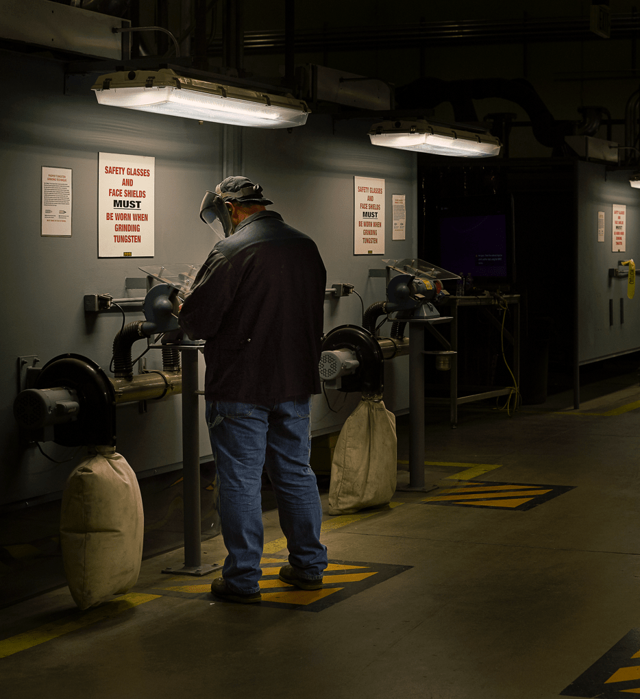 A Worker at a Grinding Machine